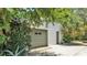 View of a detached garage surrounded by trees and foliage at 423 Avenue H Se, Winter Haven, FL 33880