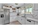 Modern kitchen with white cabinets, tile backsplash, and stainless steel refrigerator at 423 Avenue H Se, Winter Haven, FL 33880