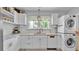 Well-lit kitchen with white cabinets, stainless steel appliances, and tile backsplash at 423 Avenue H Se, Winter Haven, FL 33880