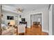 Open-concept living area with hardwood floors, fireplace, and a ceiling fan at 423 Avenue H Se, Winter Haven, FL 33880