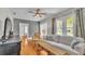 Bright living area with hardwood floors, large windows, and a cozy couch at 423 Avenue H Se, Winter Haven, FL 33880