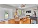 Inviting living room featuring a fireplace, wood floors, and natural light from large windows at 423 Avenue H Se, Winter Haven, FL 33880