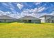 A sprawling green backyard provides ample space for outdoor activities and relaxation at 5298 Tennessee Ridge Ct, Auburndale, FL 33823