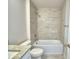 Bright bathroom featuring a granite vanity and a tiled shower-over-tub at 5298 Tennessee Ridge Ct, Auburndale, FL 33823