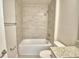Bathroom with tile shower over tub and granite-look countertop at 5298 Tennessee Ridge Ct, Auburndale, FL 33823