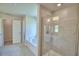 Bathroom features tile floors, a soaking tub, a walk-in shower, and neutral finishes at 5298 Tennessee Ridge Ct, Auburndale, FL 33823