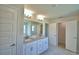 Bright bathroom with double vanity, granite counters, and a walk-in closet for optimal convenience at 5298 Tennessee Ridge Ct, Auburndale, FL 33823