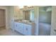Elegant bathroom featuring double sinks, granite counters, and access to the shower, tub and closet at 5298 Tennessee Ridge Ct, Auburndale, FL 33823
