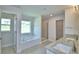 Bathroom boasts double sinks, granite counters, a soaking tub, and a separate glass shower at 5298 Tennessee Ridge Ct, Auburndale, FL 33823