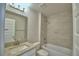 Bright bathroom featuring a granite vanity and a tiled shower-over-tub at 5298 Tennessee Ridge Ct, Auburndale, FL 33823