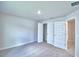 Bedroom view with carpeted floors, neutral walls, and white doors to a closet, hallway, and room at 5298 Tennessee Ridge Ct, Auburndale, FL 33823