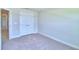 Neutral bedroom featuring carpet and double door closet at 5298 Tennessee Ridge Ct, Auburndale, FL 33823