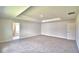 Expansive bedroom with carpeted floor and tray ceiling is a calming space, brightened by natural light at 5298 Tennessee Ridge Ct, Auburndale, FL 33823