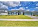 Charming single-story home with lush front lawn and beautifully landscaped front yard at 5298 Tennessee Ridge Ct, Auburndale, FL 33823