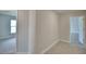 Hallway with hard surface floors leads to carpeted bedrooms and showcases the home's open floor plan at 5298 Tennessee Ridge Ct, Auburndale, FL 33823