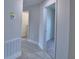 Hallway showing neutral walls and white doors. The flooring is gray wood-look tile, providing a modern touch at 5298 Tennessee Ridge Ct, Auburndale, FL 33823