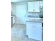 Kitchen features white cabinets, stainless steel appliances, and granite countertops at 5298 Tennessee Ridge Ct, Auburndale, FL 33823