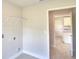Laundry room with tile floors and additional storage area at 5298 Tennessee Ridge Ct, Auburndale, FL 33823