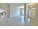 Spacious living area with light tile flooring leading into a dining area and modern kitchen at 5298 Tennessee Ridge Ct, Auburndale, FL 33823