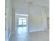 Open-concept living space with light tile flooring, bathed in natural light at 5298 Tennessee Ridge Ct, Auburndale, FL 33823