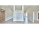 Open living area with light tile flooring, tall ceilings and neutral paint at 5298 Tennessee Ridge Ct, Auburndale, FL 33823