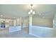 Open living space blending into a modern kitchen and dining area, with tile flooring at 5298 Tennessee Ridge Ct, Auburndale, FL 33823