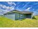 A view of the home's back exterior, featuring a covered patio and well-maintained backyard at 5298 Tennessee Ridge Ct, Auburndale, FL 33823