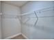 Spacious walk-in closet featuring carpeted floors and ample shelving for organized storage solutions at 5298 Tennessee Ridge Ct, Auburndale, FL 33823