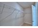 Spacious walk-in closet featuring neutral walls, carpeted floors, and ample shelving. Door is open to the room at 5298 Tennessee Ridge Ct, Auburndale, FL 33823