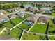 Aerial view of a home with a screened in pool, surrounded by a well manicured backyard and lake view at 5611 Aral Dr, Lakeland, FL 33805