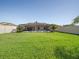 Large backyard featuring a screened-in pool area and a well-maintained lawn at 5611 Aral Dr, Lakeland, FL 33805