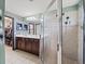 Stylish bathroom with double vanity, glass shower, and unique patterned wallpaper at 5611 Aral Dr, Lakeland, FL 33805