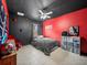 Bedroom featuring black and red color scheme, ceiling fan, and tile floor at 5611 Aral Dr, Lakeland, FL 33805