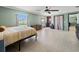 Bright bedroom with tile floor, large window with backyard view, and cozy seating area at 5611 Aral Dr, Lakeland, FL 33805