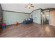 Bonus room featuring wood-look floors, neutral paint, and comfortable blue seating at 5611 Aral Dr, Lakeland, FL 33805