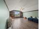 Spacious bonus room with wood-look flooring, wood accent wall, and comfortable seating at 5611 Aral Dr, Lakeland, FL 33805
