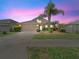 Charming home featuring a two-car garage and a well-manicured lawn with beautiful landscaping at 5611 Aral Dr, Lakeland, FL 33805