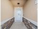 Inviting front porch featuring stone accents and a white trimmed doorway at 5611 Aral Dr, Lakeland, FL 33805