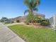 Nice view of the home's exterior, showcasing the driveway, landscaping, and street view at 5611 Aral Dr, Lakeland, FL 33805