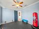 This home gym features blue walls, rubber flooring, and workout equipment at 5611 Aral Dr, Lakeland, FL 33805