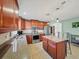 Well-lit kitchen with stainless steel appliances, granite countertops, and a center island at 5611 Aral Dr, Lakeland, FL 33805