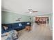 Open living room with sliding glass door, tile floors and ceiling fan at 5611 Aral Dr, Lakeland, FL 33805