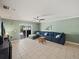 Open living room with sliding glass door, tile floors and ceiling fan at 5611 Aral Dr, Lakeland, FL 33805