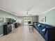 Open living room with sliding glass door, tile floors and ceiling fan at 5611 Aral Dr, Lakeland, FL 33805