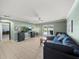 Open living room with sliding glass door, tile floors and ceiling fan at 5611 Aral Dr, Lakeland, FL 33805
