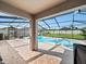 Screened-in pool area with a tile patio, landscaped yard, and blue sky at 5611 Aral Dr, Lakeland, FL 33805