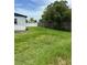 Spacious backyard with lush green grass and a privacy fence, ideal for outdoor activities at 5907 Sharon Ln, Lakeland, FL 33809