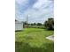 Large backyard with ample green space, storage shed, and potential for landscaping or recreation at 5907 Sharon Ln, Lakeland, FL 33809