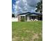 Charming single-story home with brick accents, covered carport, and well-maintained front lawn at 5907 Sharon Ln, Lakeland, FL 33809