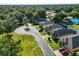 An aerial shot shows the home nestled on a cul-de-sac within a lush, green neighborhood with mature trees at 6408 Christina Chase Pl, Lakeland, FL 33813